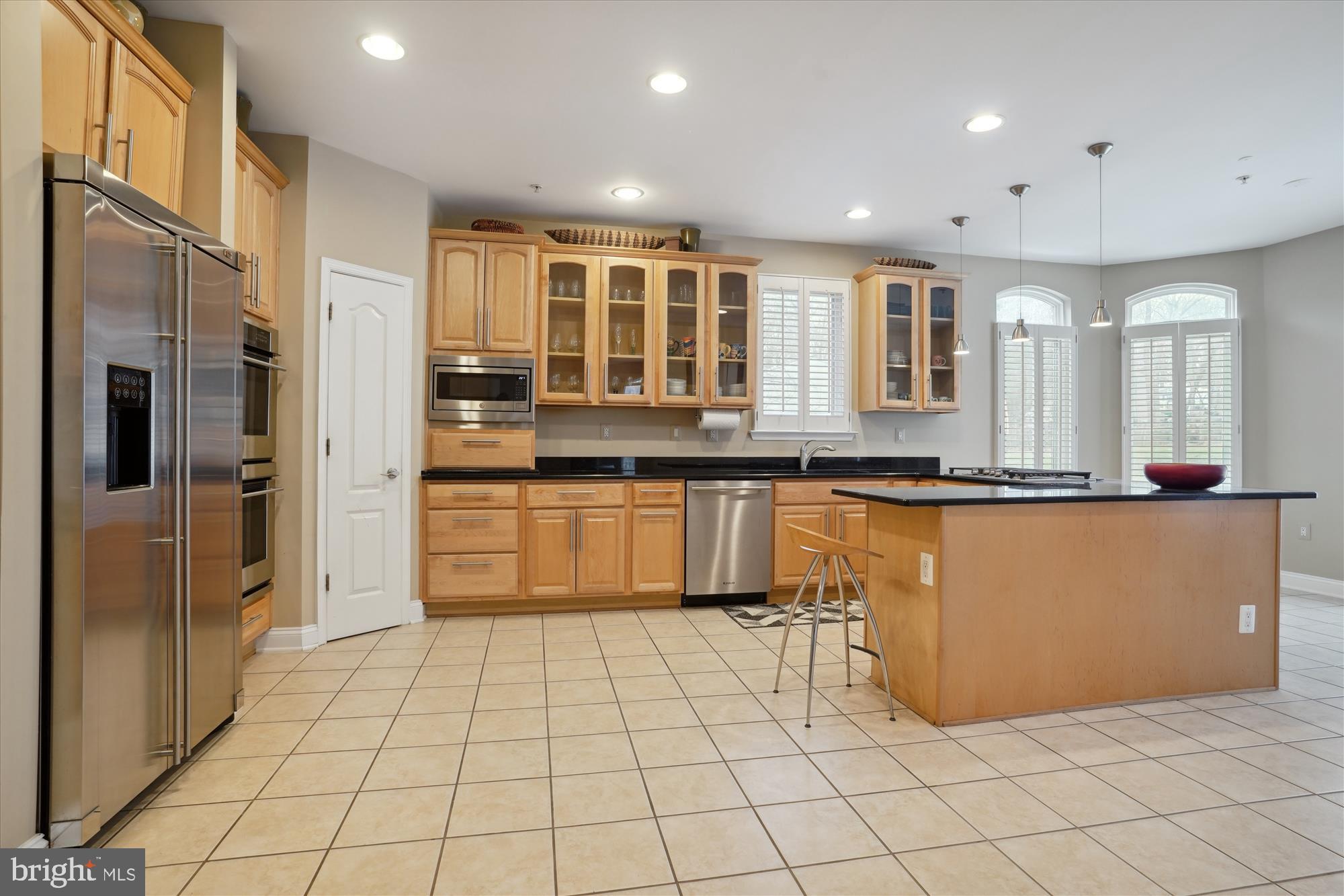 17410 Queen Anne Road Upper Marlboro, MD 20774 - Photo 25 of 82 a large kitchen with stainless steel appliances granite countertop a refrigerator and a stove