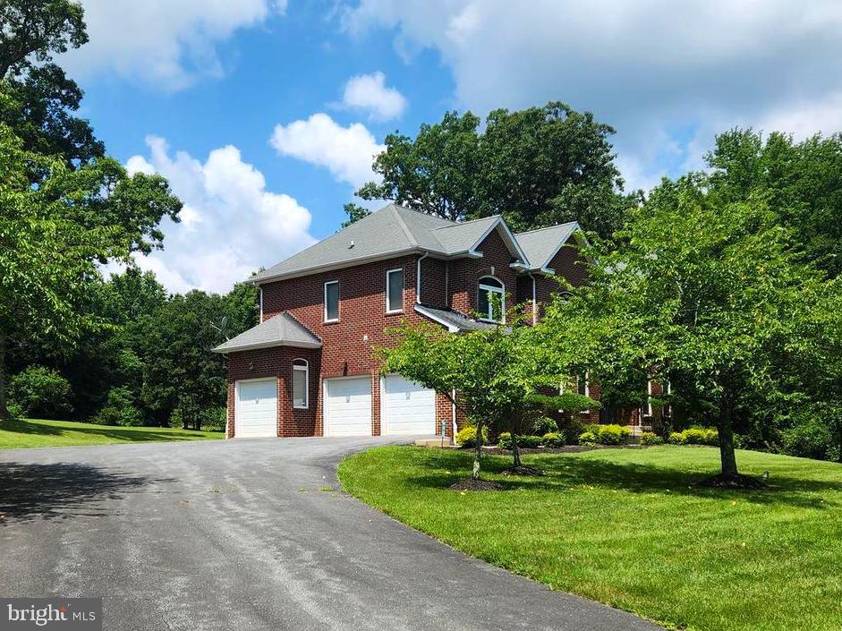 17410 Queen Anne Road Upper Marlboro, MD 20774 - Photo 30 of 82 a front view of a house with a yard