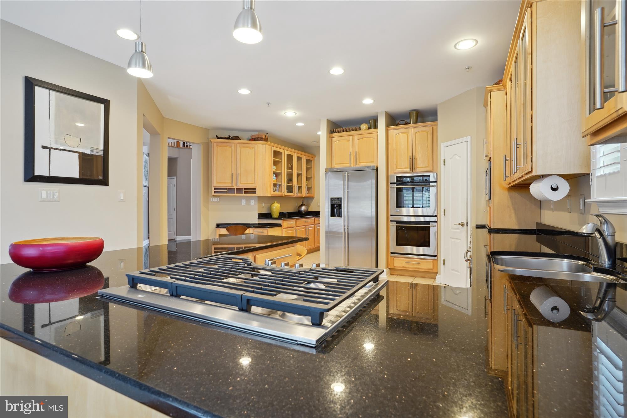 17410 Queen Anne Road Upper Marlboro, MD 20774 - Photo 32 of 82 a kitchen with stainless steel appliances granite countertop a stove and a refrigerator