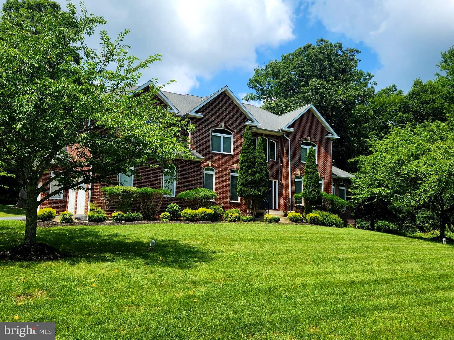 17410 Queen Anne Road Upper Marlboro, MD 20774 - Photo 81 of 82 a front view of a house with a yard and trees