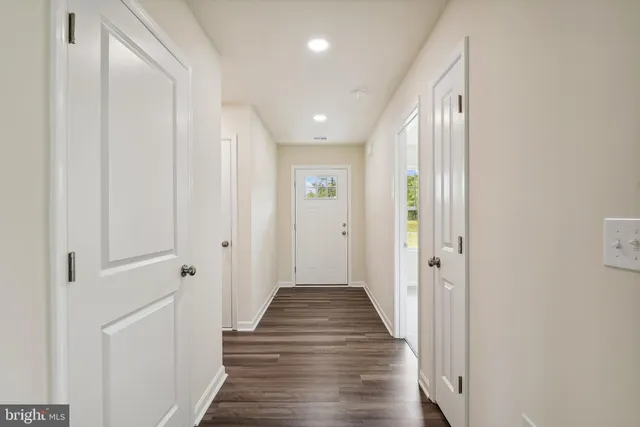 a view of a hallway with wooden floor