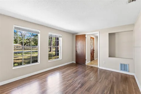 wooden floor in an empty room with a window