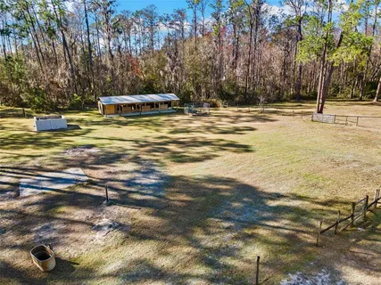 a view of a house with a backyard and sitting area