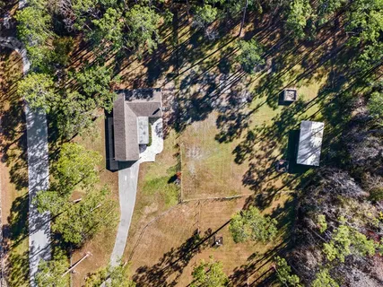 a view of large space covered with snow in front of house
