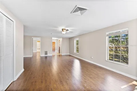 a kitchen with stainless steel appliances granite countertop a refrigerator a sink a stove and oven with wooden floors