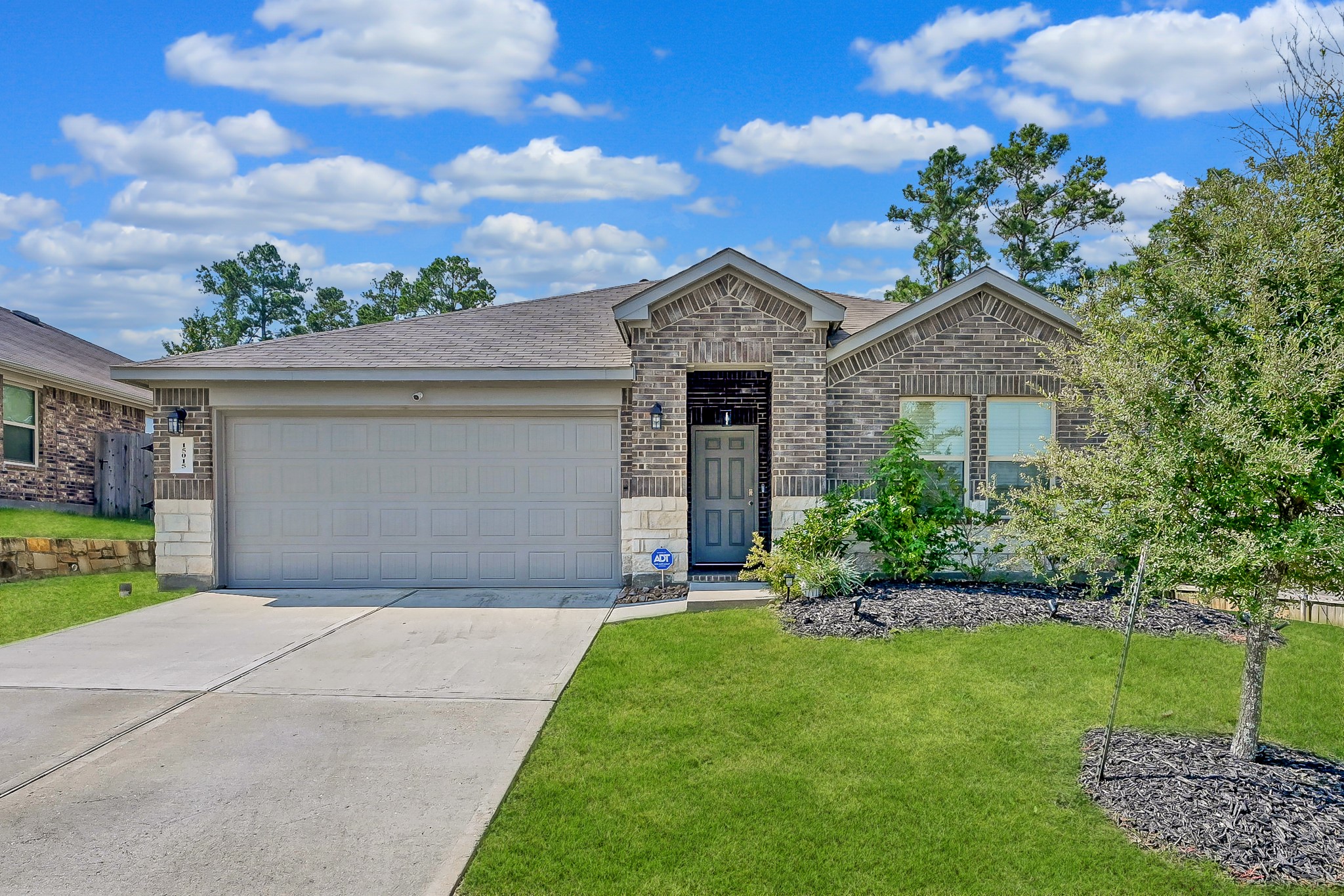 15015 Monserrat Lane Conroe, TX 77304 - Photo 1 of 41 a front view of a house with a yard and garage