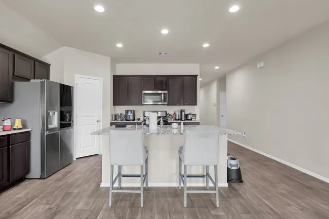 a kitchen with refrigerator and microwave