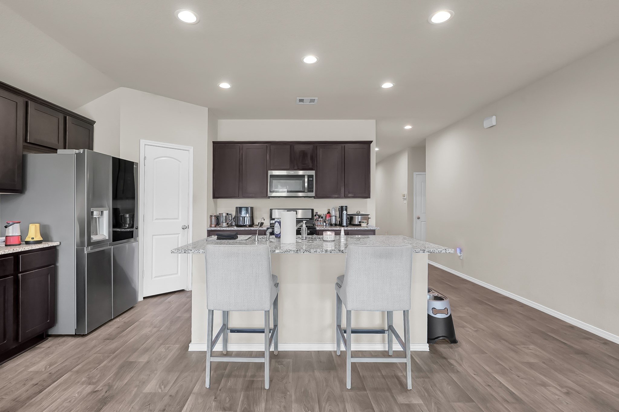 15015 Monserrat Lane Conroe, TX 77304 - Photo 11 of 41 a kitchen with refrigerator and microwave