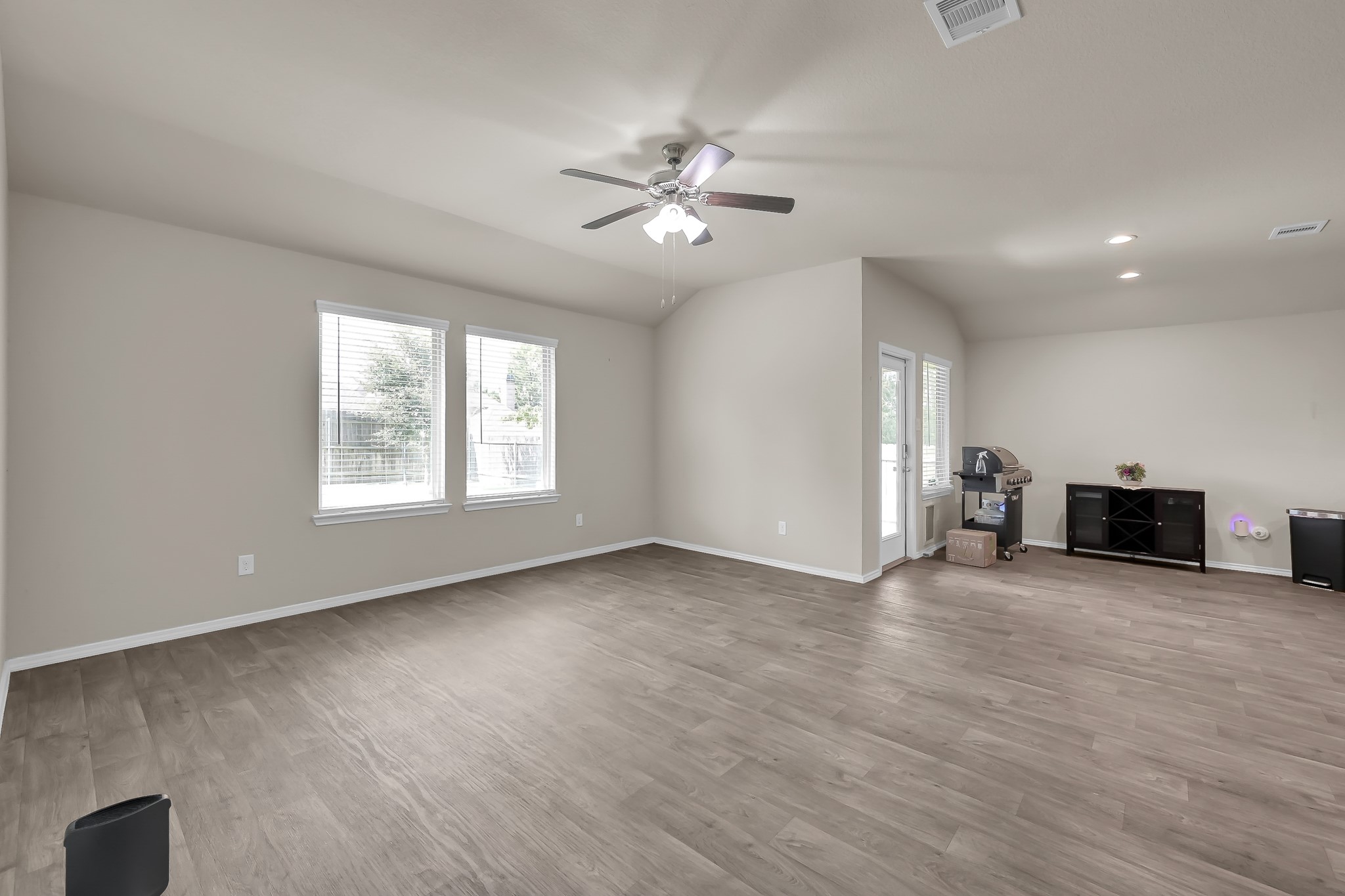 15015 Monserrat Lane Conroe, TX 77304 - Photo 18 of 41 a view of an empty room with a window and wooden floor