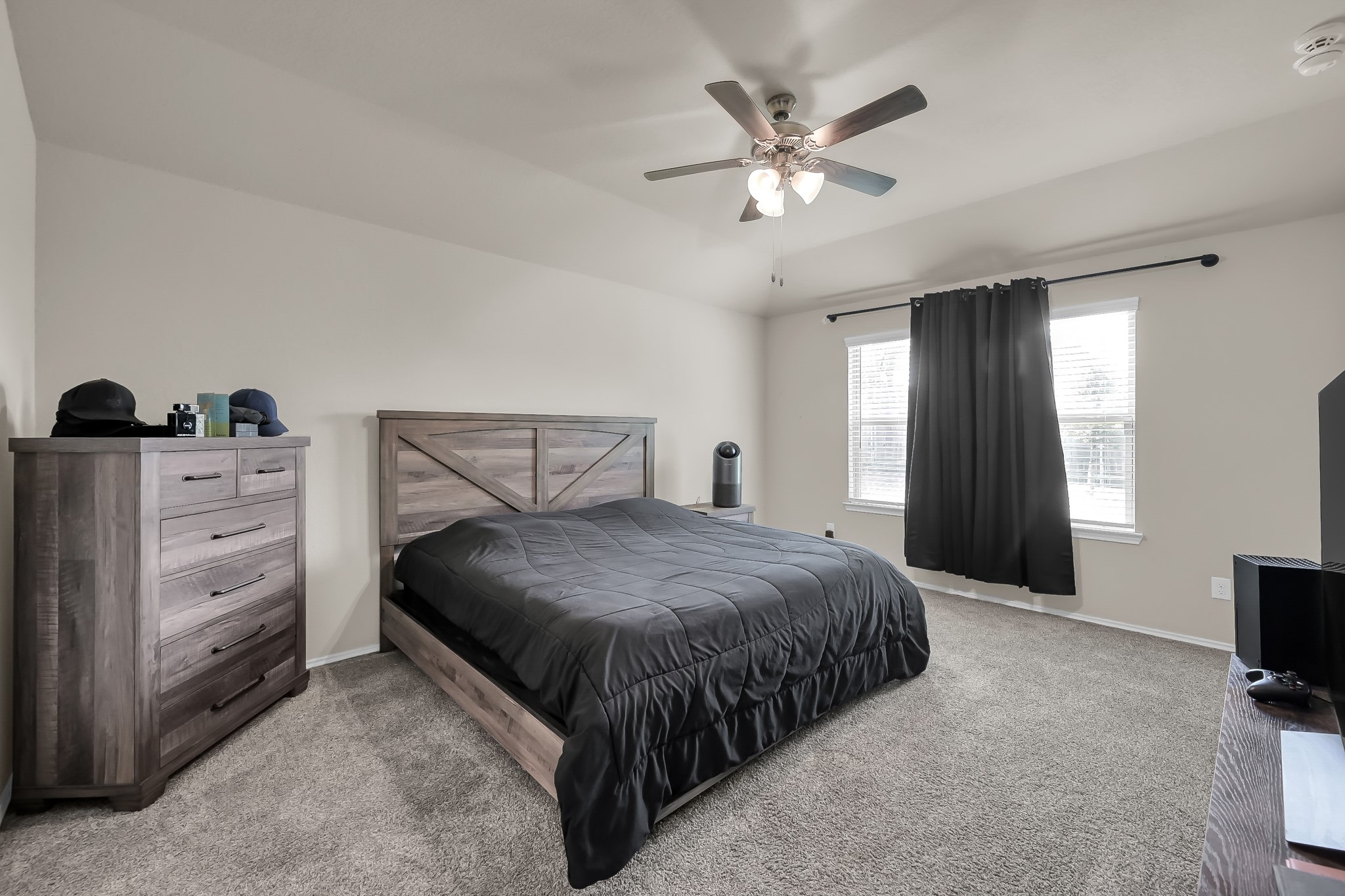15015 Monserrat Lane Conroe, TX 77304 - Photo 20 of 41 a bedroom with a bed and a chandelier