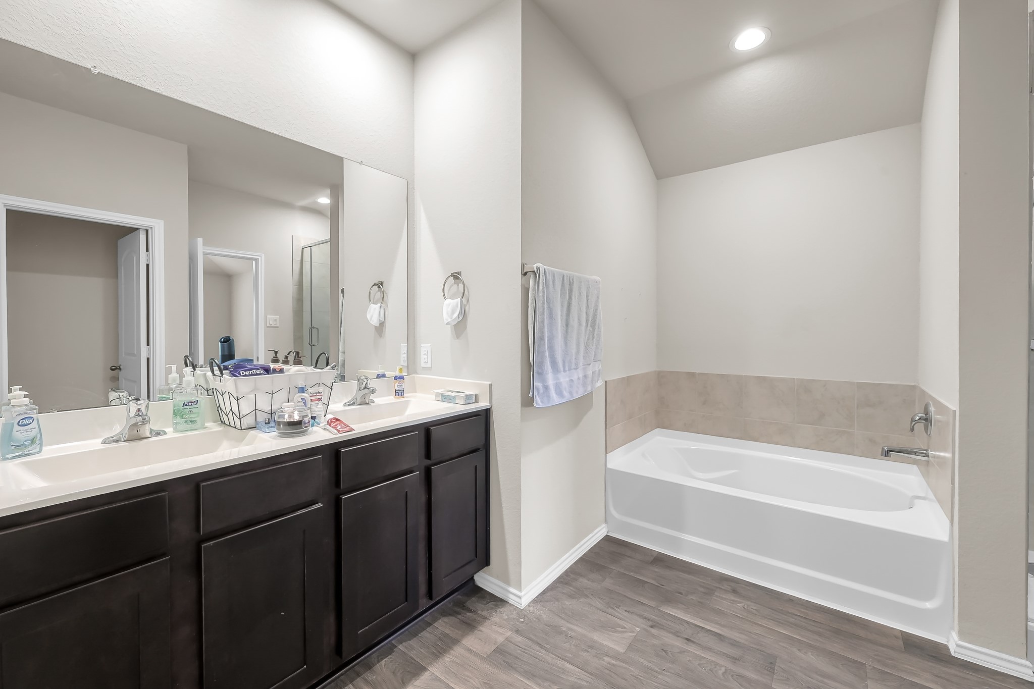 15015 Monserrat Lane Conroe, TX 77304 - Photo 23 of 41 a bathroom with a tub a sink and mirror