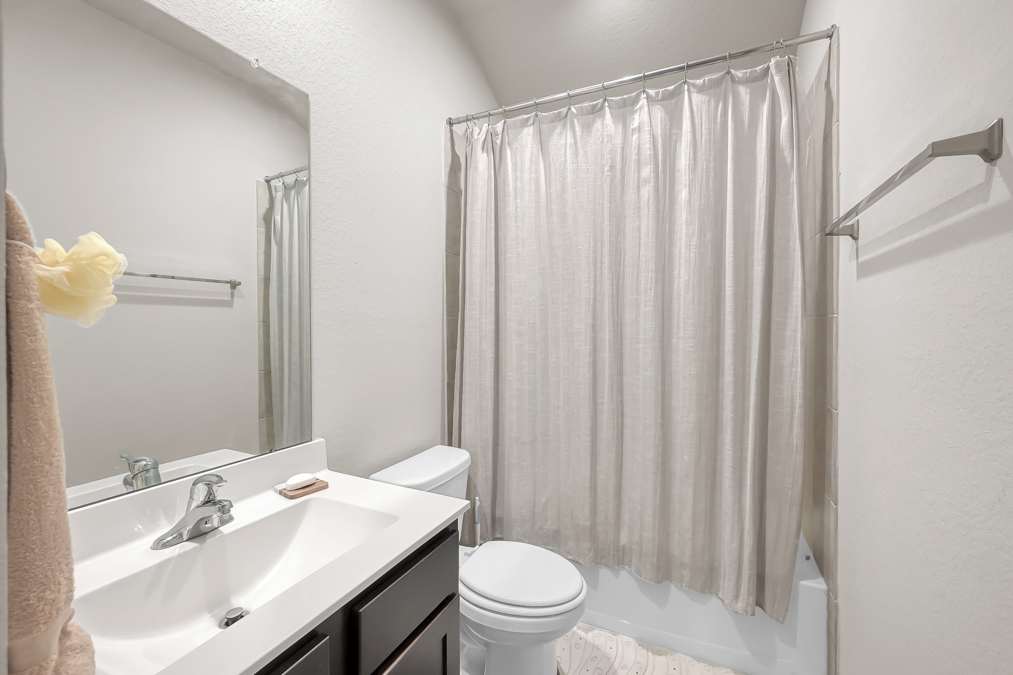 15015 Monserrat Lane Conroe, TX 77304 - Photo 27 of 41 a bathroom with a sink a toilet and shower curtain