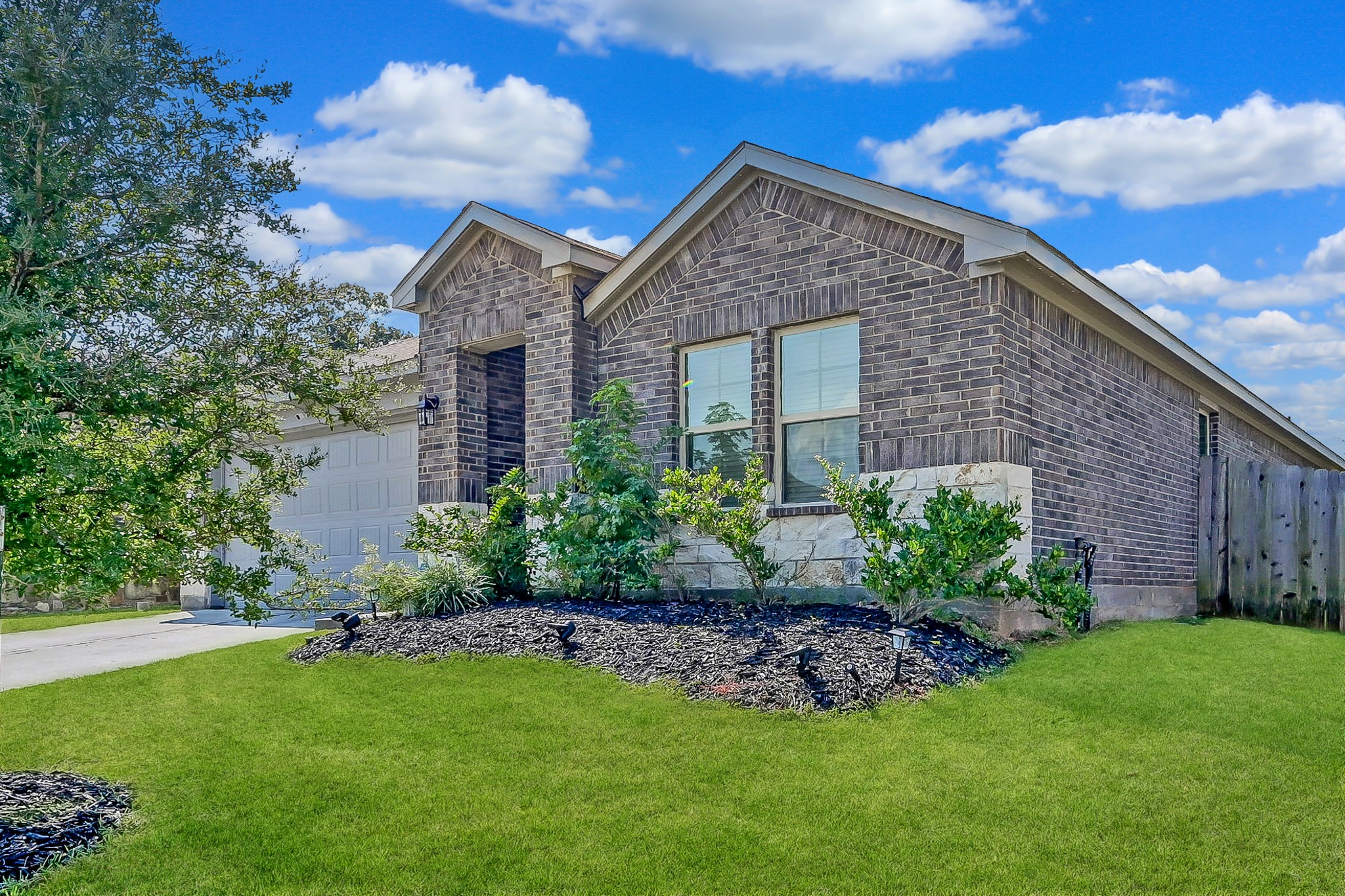 15015 Monserrat Lane Conroe, TX 77304 - Photo 3 of 41 a front view of a house with a garden