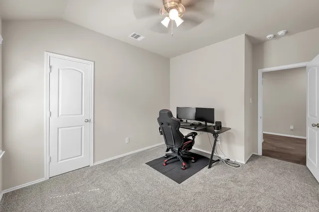 a house with green field in front of it