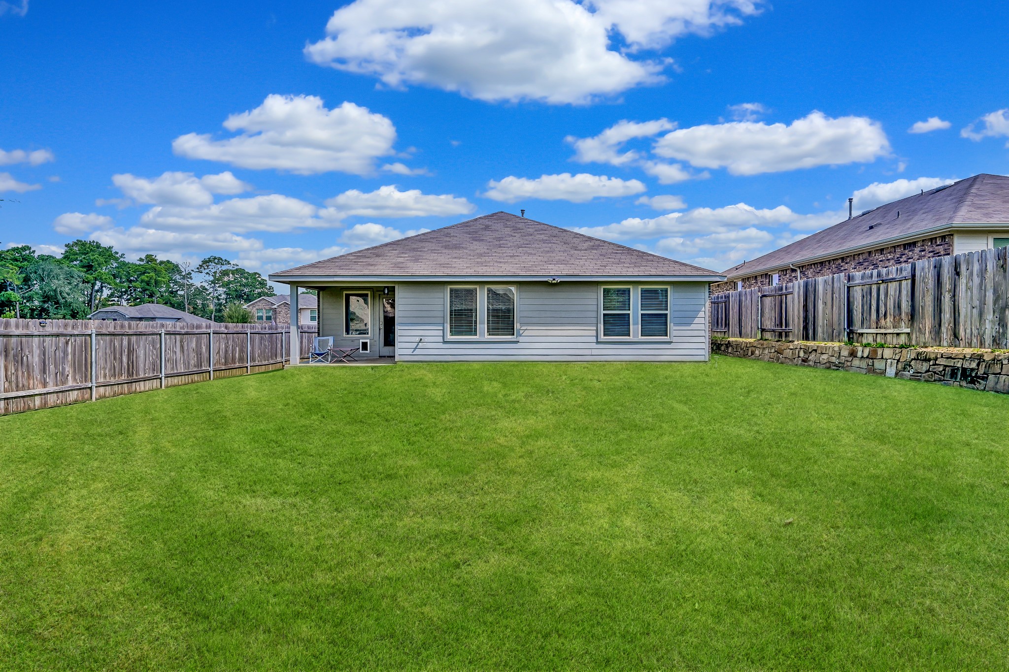 15015 Monserrat Lane Conroe, TX 77304 - Photo 37 of 41 a view of a house with a yard