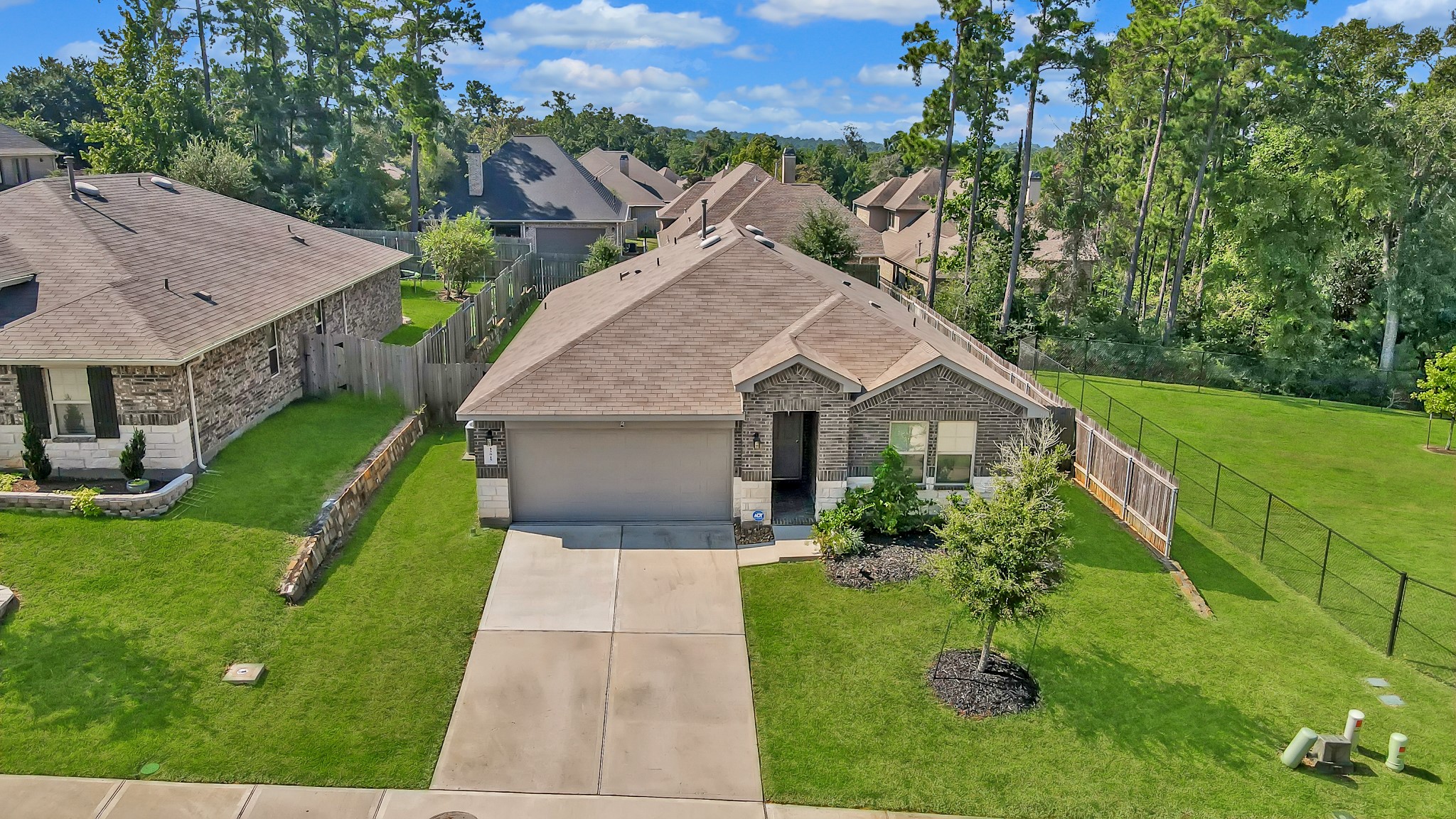 15015 Monserrat Lane Conroe, TX 77304 - Photo 39 of 41 a house with green field in front of it