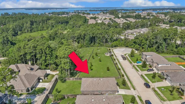 an aerial view of a houses with a green and yard