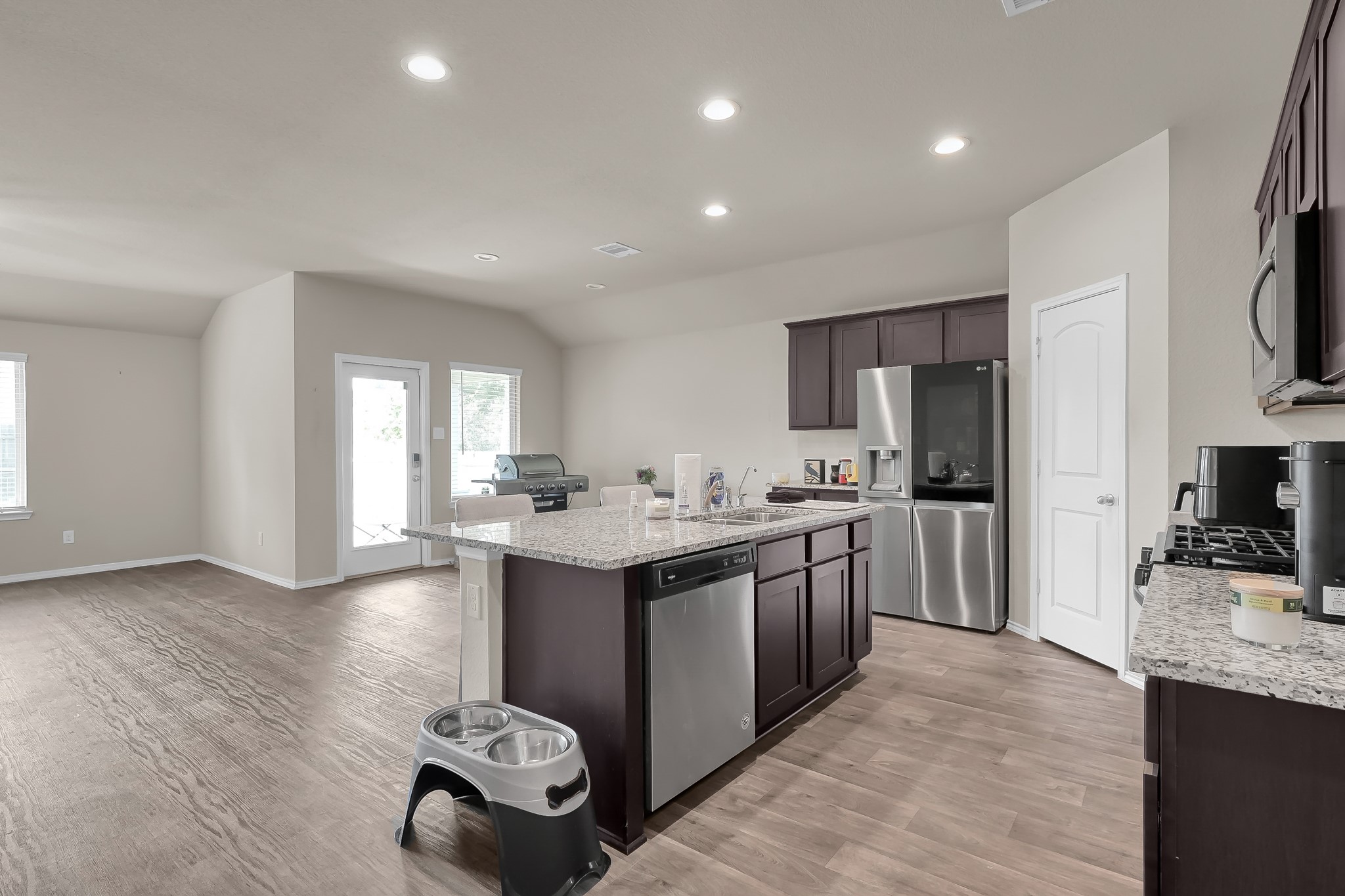 15015 Monserrat Lane Conroe, TX 77304 - Photo 8 of 41 a kitchen with stainless steel appliances granite countertop a sink stove and refrigerator
