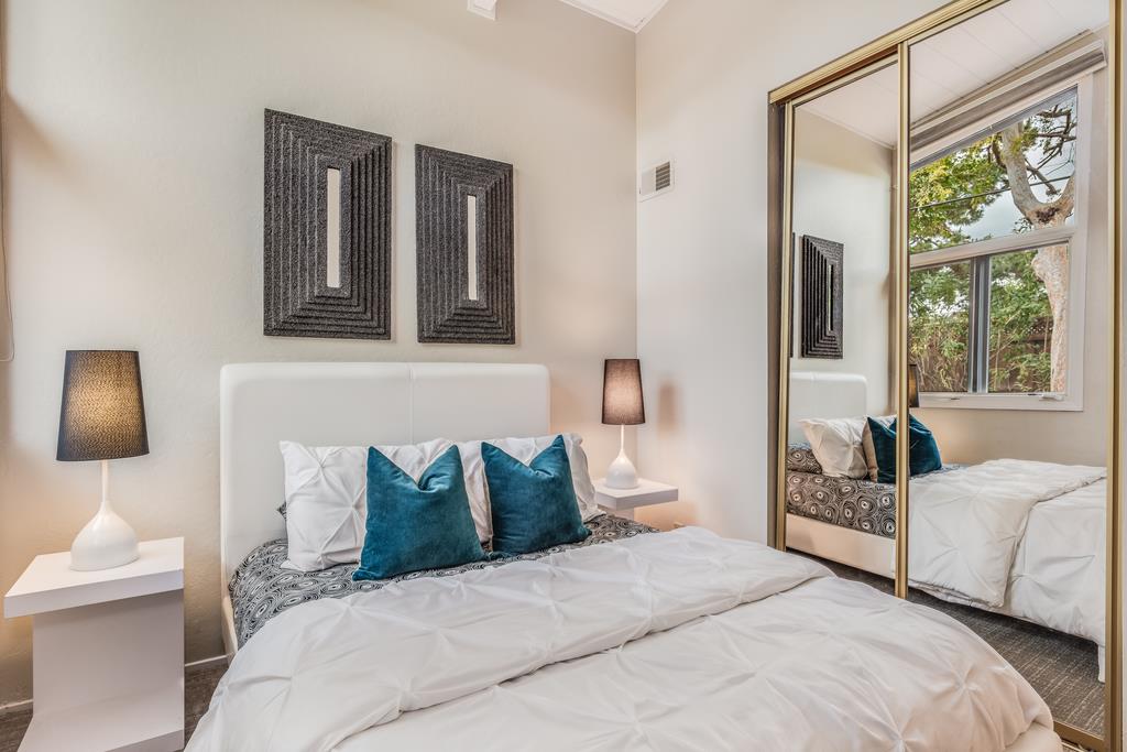 1372 Flicker Way Sunnyvale, CA 94087 - Photo 12 of 22 a bedroom with a bed window and a night stand