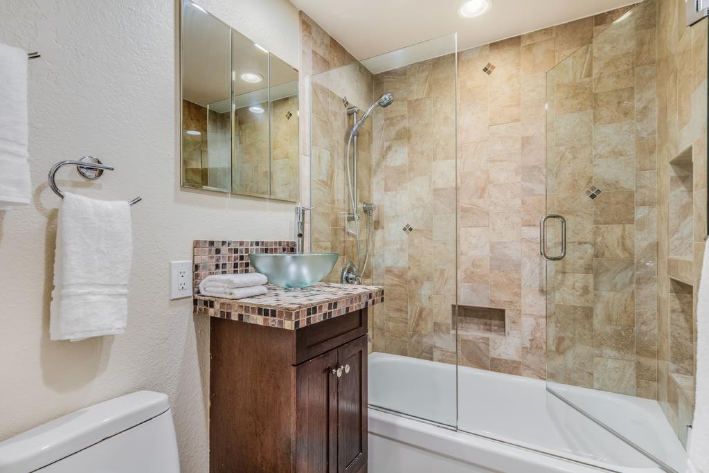 1372 Flicker Way Sunnyvale, CA 94087 - Photo 16 of 22 a bathroom with a granite countertop sink a toilet and shower