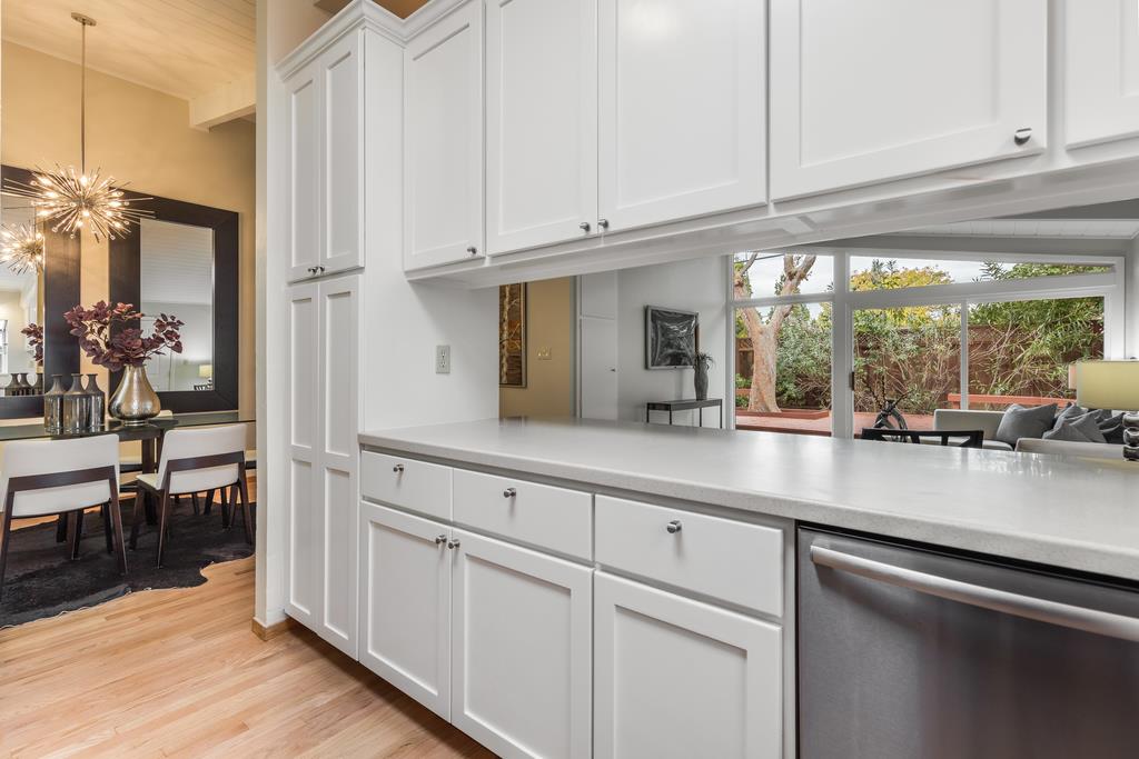1372 Flicker Way Sunnyvale, CA 94087 - Photo 4 of 22 a kitchen with stainless steel appliances granite countertop a refrigerator a sink and cabinets