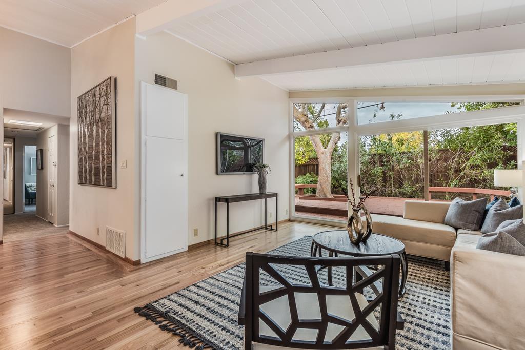 1372 Flicker Way Sunnyvale, CA 94087 - Photo 8 of 22 a living room with furniture and a floor to ceiling window