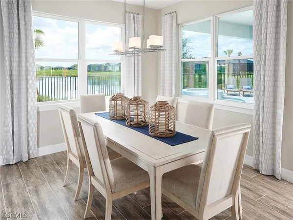 a dining room with furniture a chandelier and wooden floor