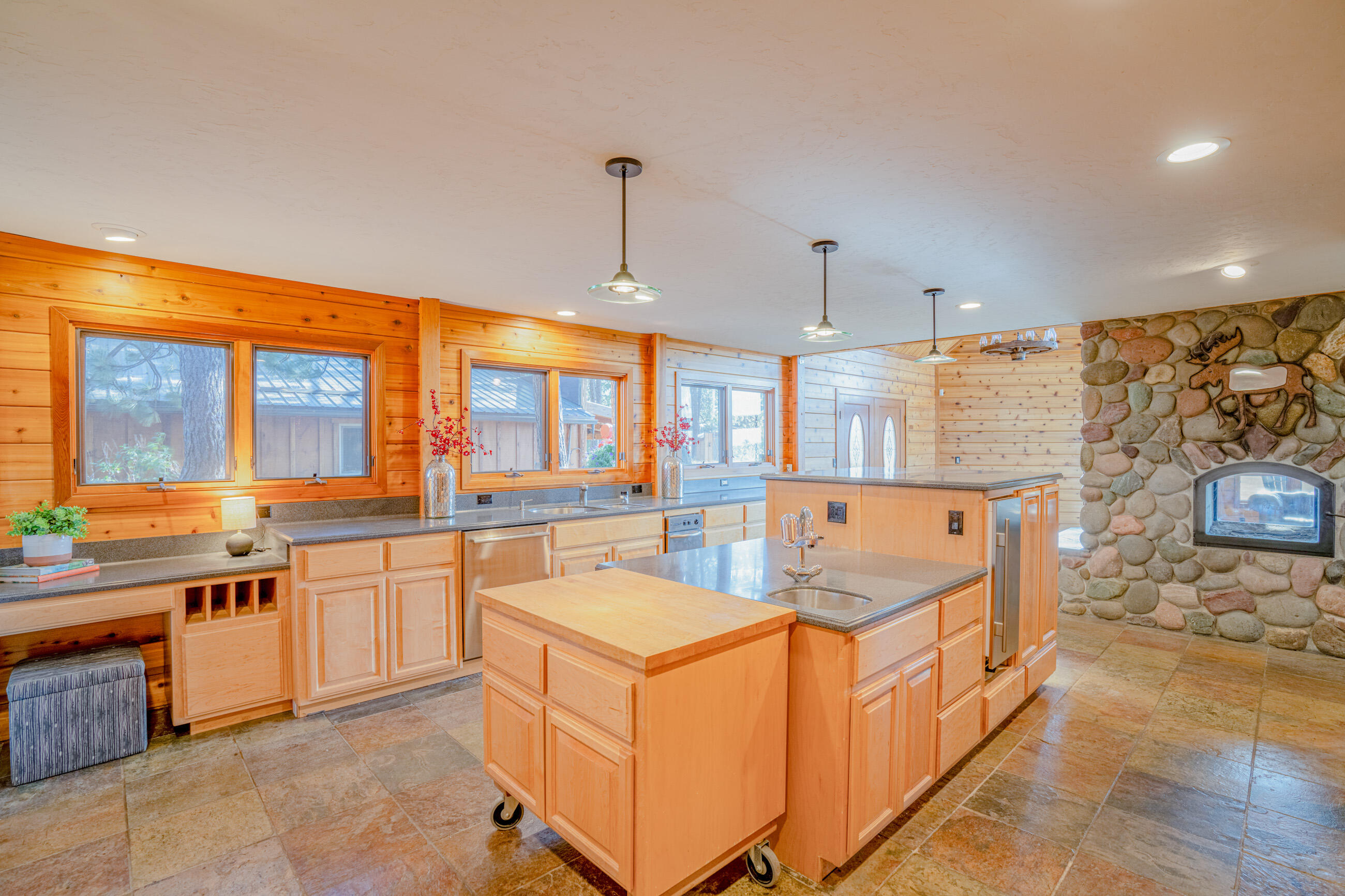 60647 Antler Road Bend, OR 97702 - Photo 14 of 44 a large kitchen with stainless steel appliances granite countertop a sink and cabinets