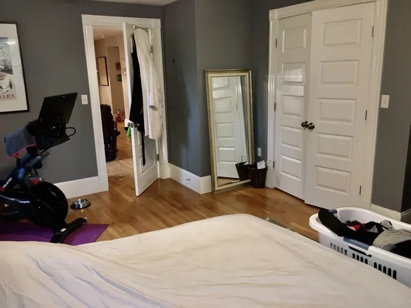 a bedroom with a bed and a mirror