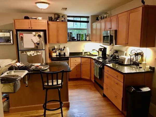 a kitchen with a sink appliances and cabinets