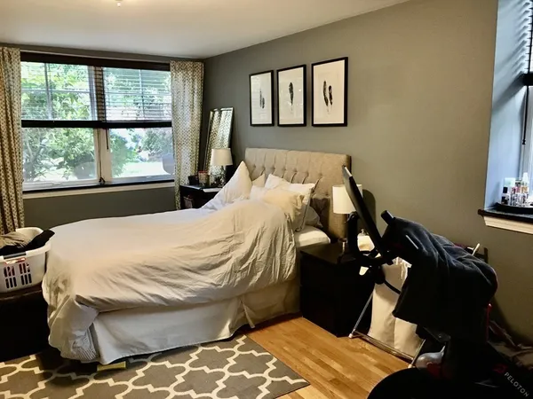 a bed sitting in a bedroom next to a window