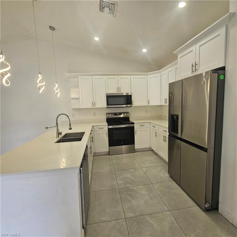 4722 29th Street Southwest Lehigh Acres, FL 33973 - Photo 5 of 12 a kitchen with granite countertop a refrigerator and a sink