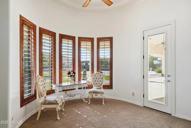 a view of a dining room with furniture and chandelier