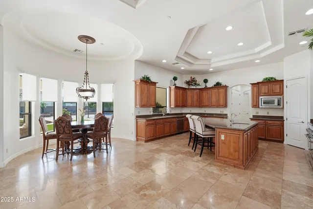 a kitchen with stainless steel appliances kitchen island granite countertop a sink and cabinets