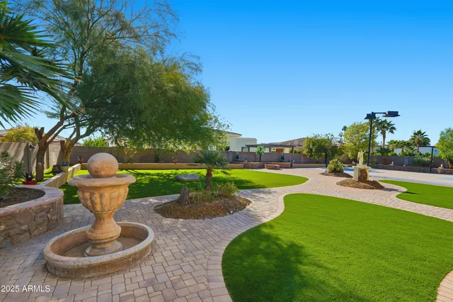 an aerial view of residential houses with outdoor space and lake view