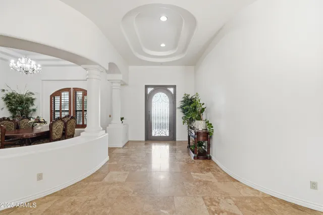 a living room with fireplace furniture and a large window