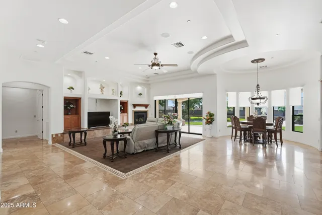 a living room with furniture a chandelier and a rug