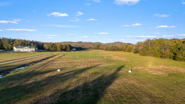 a kitchen with stainless steel appliances granite countertop wooden floors and sink