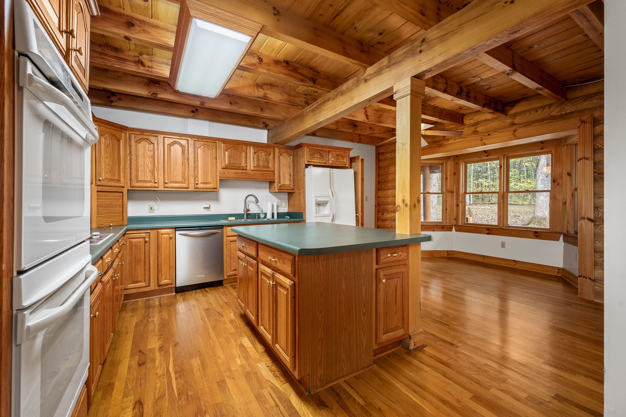 9203 Cobb Road Christiana, TN 37037 - Photo 50 of 96 a kitchen with stainless steel appliances granite countertop wooden floors and sink