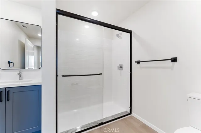 a bathroom with a shower and a mirror