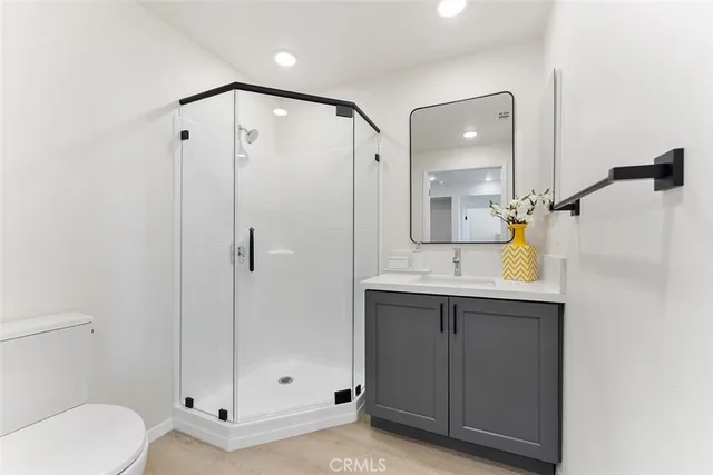 a bathroom with a shower sink and mirror