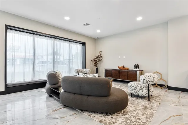 a living room with furniture and large windows
