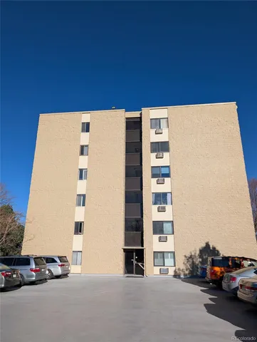 a view of building with parked cars