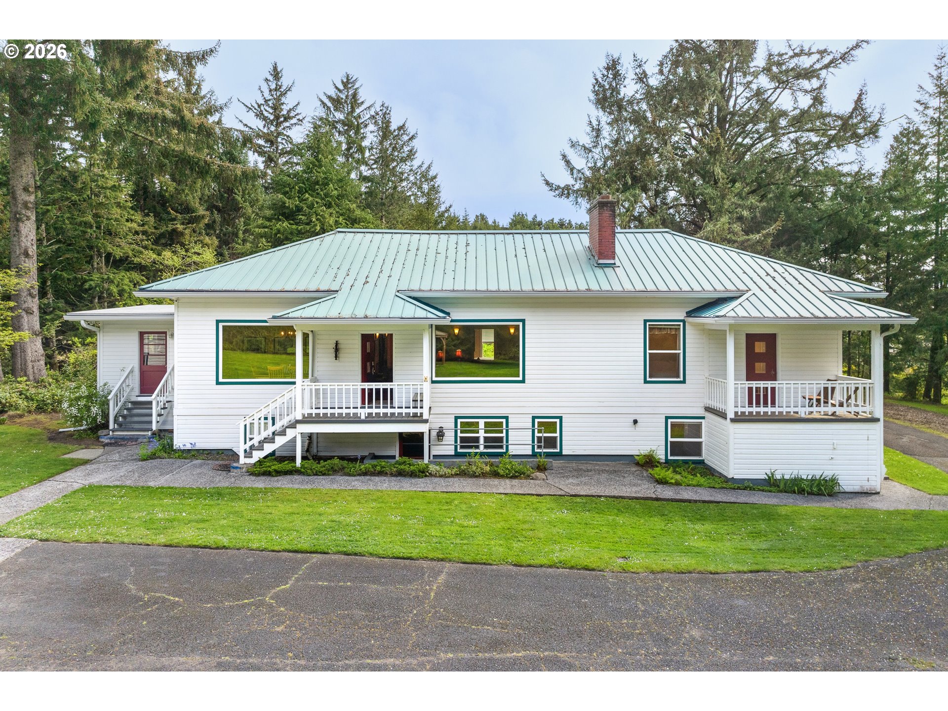 36725 North Highway 101 Nehalem, OR 97131 - Photo 1 of 40 a view of a yard in front of a house with a large tree