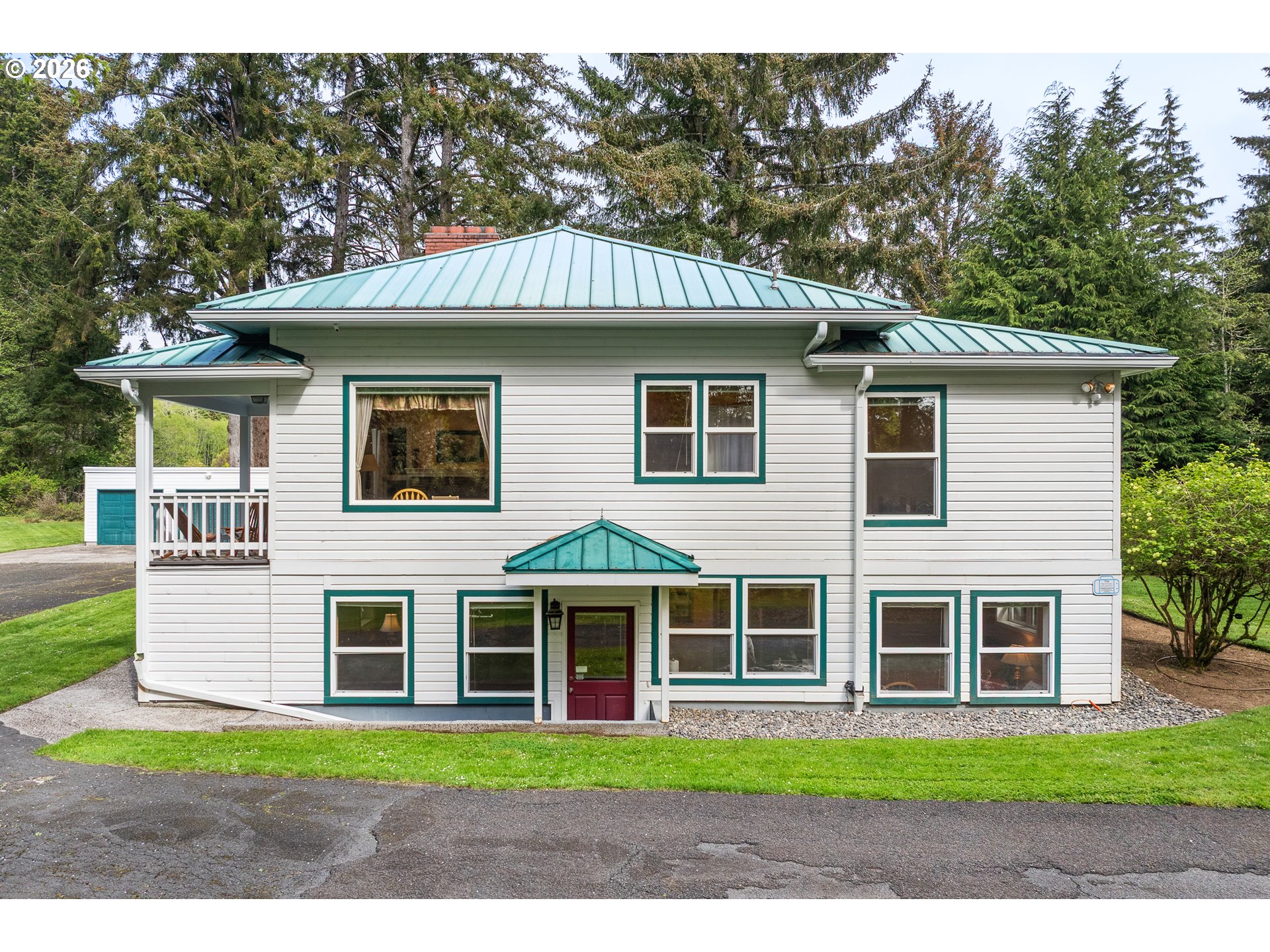 36725 North Highway 101 Nehalem, OR 97131 - Photo 3 of 40 a front view of a house with a garden
