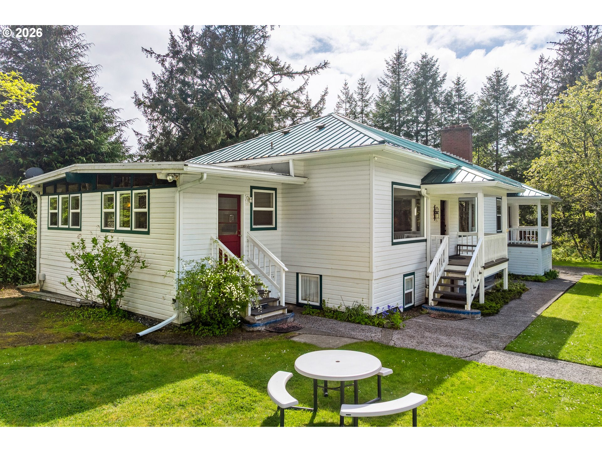 36725 North Highway 101 Nehalem, OR 97131 - Photo 36 of 40 a front view of a house with a yard fire pit and outdoor seating