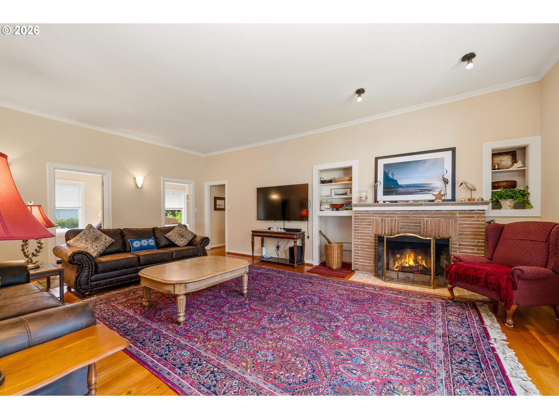 36725 North Highway 101 Nehalem, OR 97131 - Photo 7 of 40 a living room with furniture a flat screen tv and a fireplace