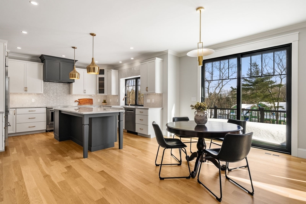 15 Whisper Way Hopkinton, MA 01748 - Photo 6 of 41 a kitchen with stainless steel appliances a dining table chairs stove and refrigerator