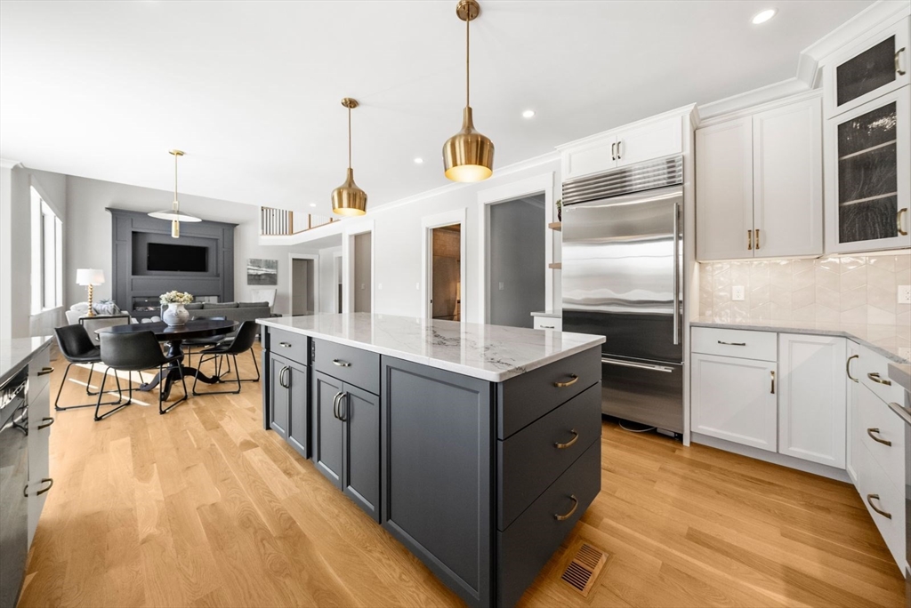 15 Whisper Way Hopkinton, MA 01748 - Photo 9 of 41 a kitchen with granite countertop a sink stove and refrigerator