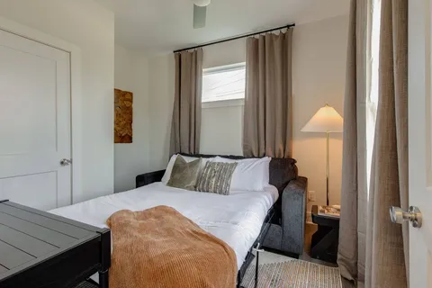 a bedroom with a bed and a table